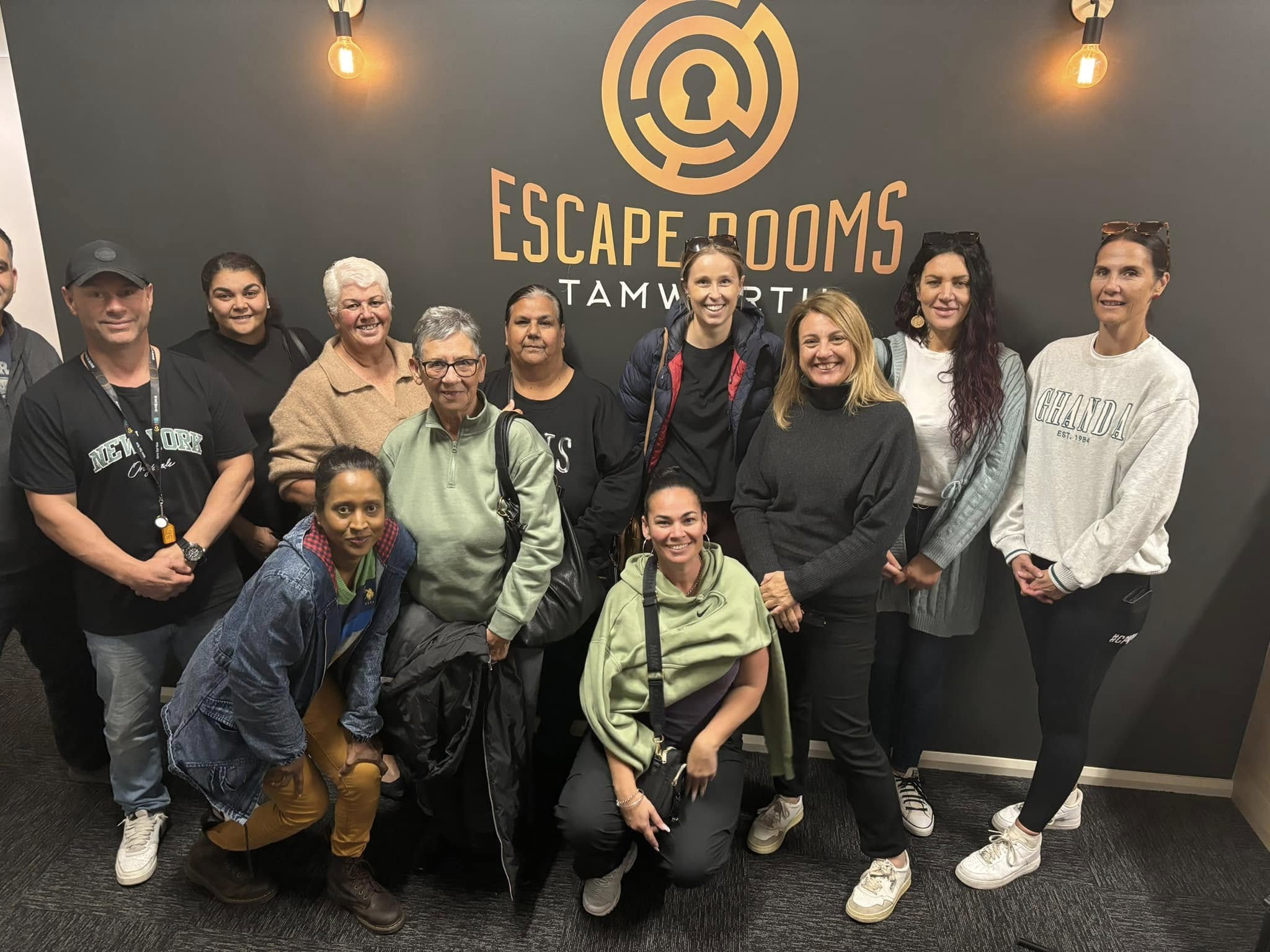 A friendly group of community members smiling together indoors